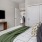 a room with a bed and a television