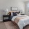 a bedroom with a bed and lamps