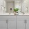a bathroom with white cabinets