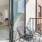a room with a glass door and a table and chairs