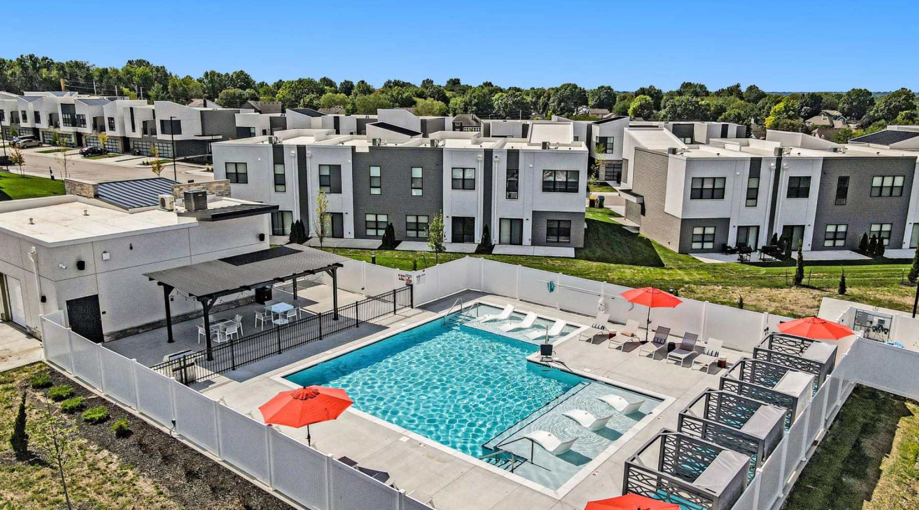 The essence of exceptional living a swimming pool in front of a large white building
