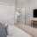 a bedroom with a tv and bed