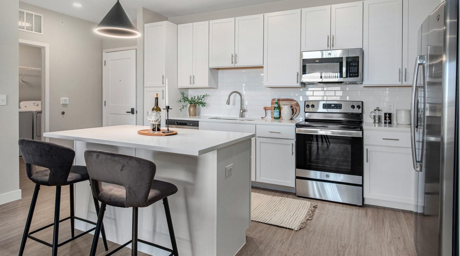 Settle into comfort at The Signature at West Pryor a kitchen with white cabinets