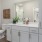 a bathroom with white cabinets